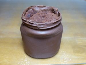 Image showing a cast chocolate nutella jar with nutella cupcakes inside