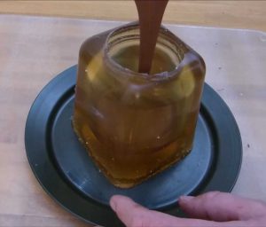 Image showing melted chocolate being poured into a Gelatin / glycerin nutella jar mould
