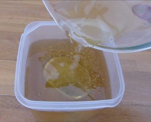 Image showing gelatine / glycerin moulding material being poured over nutella jar